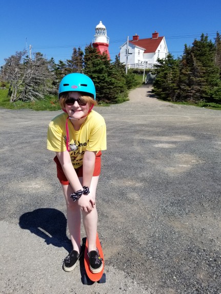 Emma (11) enjoying her "penny board" at Long Point lighthouse, Twillingate